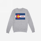 Heather-gray crewneck sweatshirt featuring the Colorado No Kings Flag Shirt design: a distressed Colorado state flag with NO KINGS NO MASTERS slogan, symbolizing autonomy and rebellion. Supports Colorado Immigrant Rights Coalition.