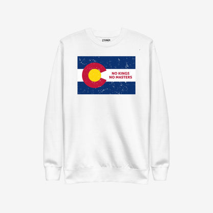 The Colorado No Kings Flag Hoodie & Sweatshirt features a distressed Colorado flag graphic with the bold message “NO KINGS NO MASTERS,” embodying a spirit of defiance and independence.