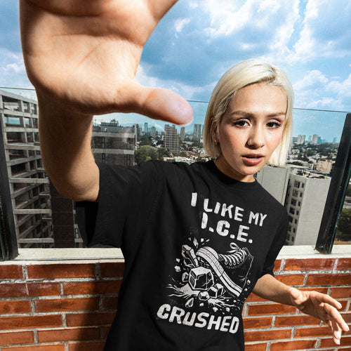 A young person wearing a Crushed ICE T-shirt with a sneaker and ice cube graphic extends their hand toward the camera, standing against a city skyline backdrop.
