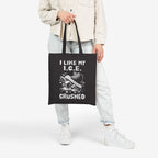 Crushed ICE Tote Bag features a powerful graphic of a sneaker crushing ice cubes with the slogan “I LIKE MY I.C.E. CRUSHED.”, symbolizing a bold stance for immigrant rights and equality.
