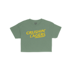 Crushin' Lagers Women's Baby Tee features bold yellow CRUSHIN’ LAGERS text on a green crop top, exuding retro varsity vibes