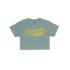 Crushin' Lagers Women's Baby Tee features bold, yellow “CRUSHIN’ LAGERS” text on a navy blue, cropped tee. Perfect for 