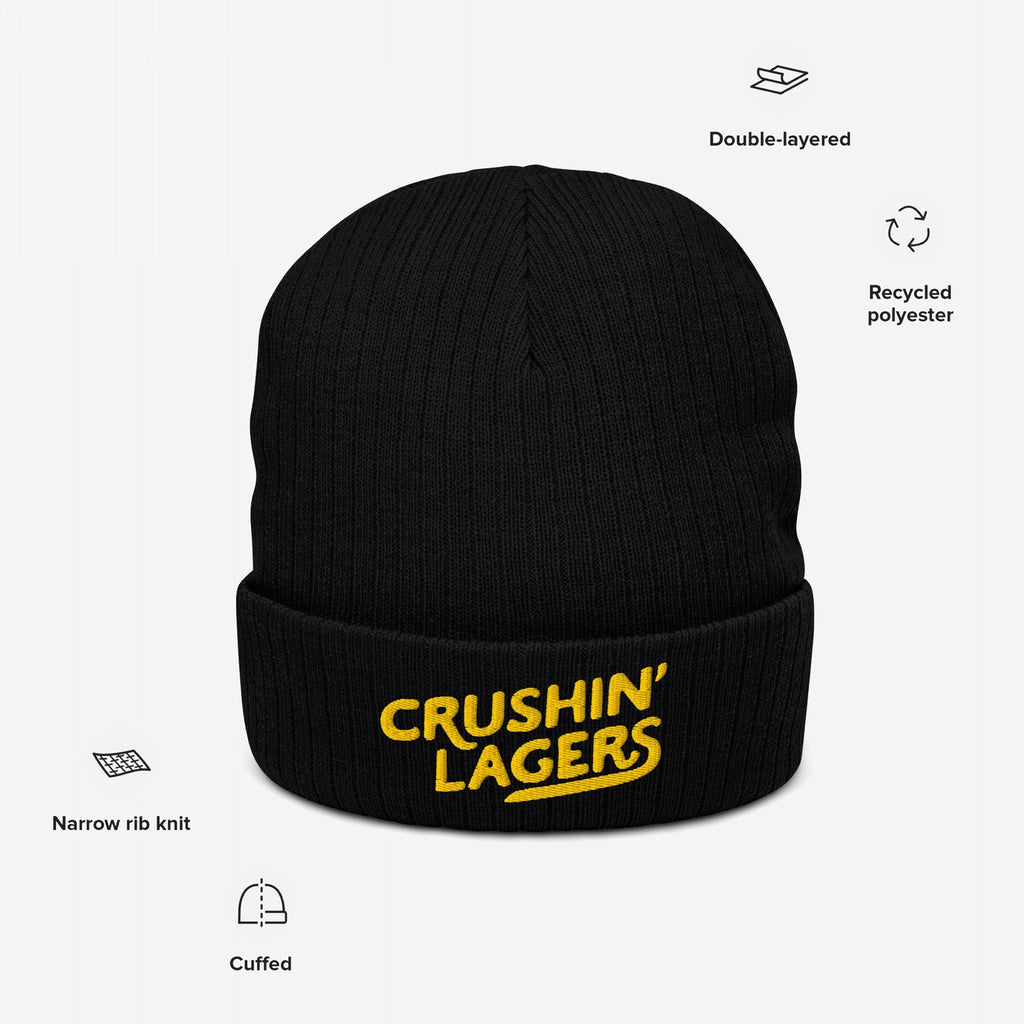 Crushin' Lagers Hat: Black cuffed knit beanie with CRUSHIN’ LAGERS in bold yellow embroidery, made from recycled polyester, featuring narrow rib knit and double-layered design. Ideal for lager enthusiasts.