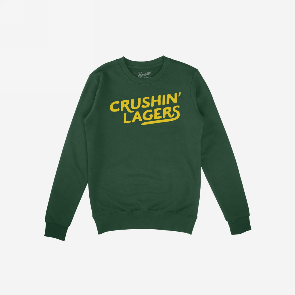 Forest-green crewneck sweatshirt with bold yellow “CRUSHIN’ LAGERS” print, embodying a rebellious, carefree attitude. Perfect for casual, comfort-focused beer enthusiasts embracing a laid-back, inclusive lifestyle.