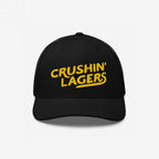 Crushin' Lagers Hat features a black mesh-back trucker design with bold yellow embroidery, curved visor, and snapback closure, perfect for celebrating beer culture with a retro vibe.