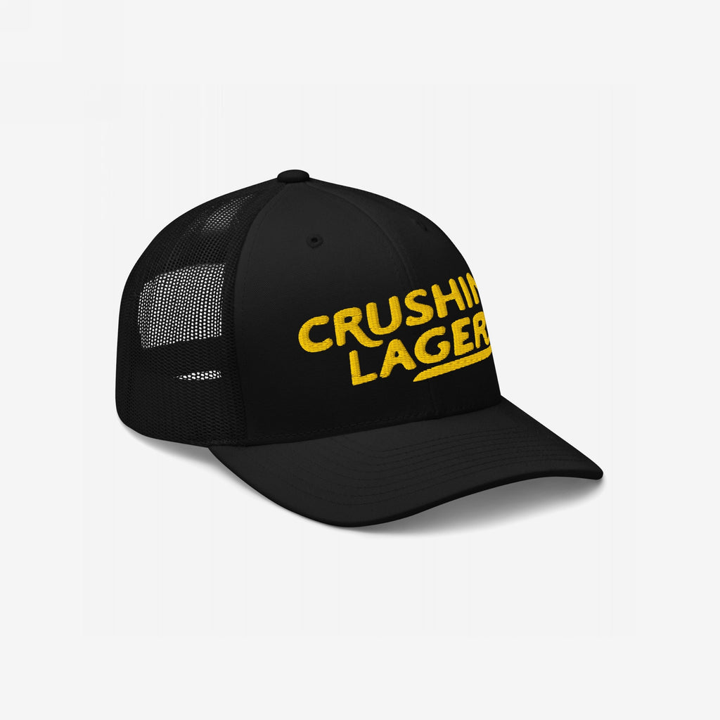 Crushin' Lagers Hat: A black trucker-style cap with mesh panels, featuring CRUSHING LAGERS in yellow. This retro-inspired hat celebrates simple pleasures like good beer and good vibes.