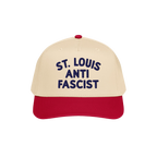 Custom Anti-Fascist 5-Panel Hat featuring a light beige crown with bold dark blue ST. LOUIS ANTI FASCIST text, red bill, and 