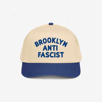 Custom Anti-Fascist 5-Panel Hat with a beige crown and navy brim features bold blue BROOKLYN ANTI FASCIST embroidery, offering a stylish, structured design perfect for activism and personalization.