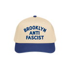 Custom Anti-Fascist 5-Panel Hat with a beige crown and navy brim features bold blue BROOKLYN ANTI FASCIST embroidery, offerin
