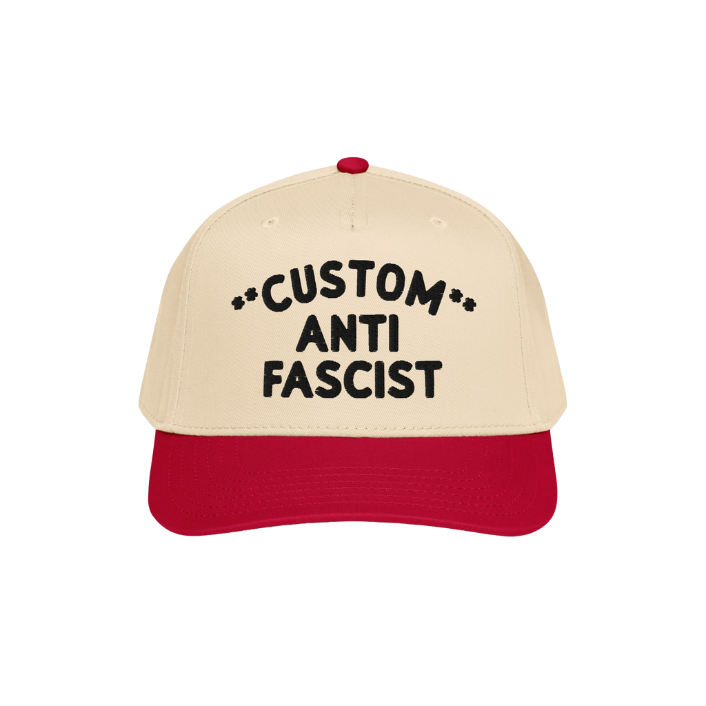 Custom Anti-Fascist 5-Panel Hat with beige crown and red bill, featuring bold black CUSTOM ANTI FASCIST embroidery, symbolizi