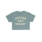Custom Anti-Fascist Women's Baby Tee featuring bold NEW YORK ANTI FASCIST text in white block letters, embodying a retro Y2K 