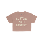Custom Anti-Fascist Women's Baby Tee featuring bold cream text on a pink background, perfect for expressing personal activism
