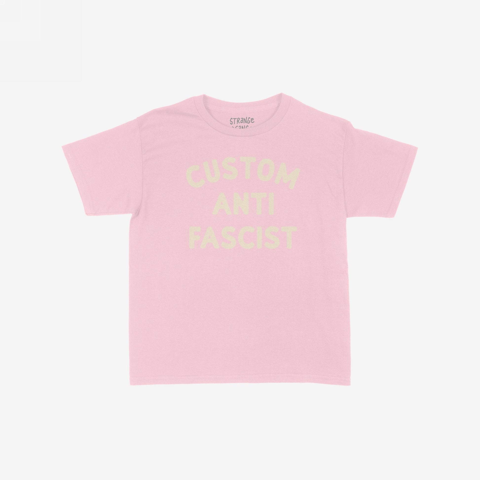 Custom Anti-Fascist Women's Baby Tee, featuring bold block lettering across the chest. This cropped pastel-pink tee combines vintage Y2K style with an activist message, embodying a modern rebel's spirit.