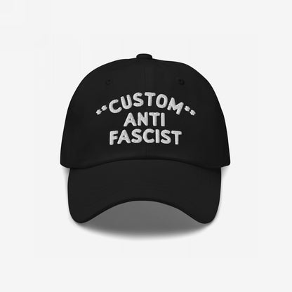 Custom Anti-Fascist Dad Hat featuring white embroidered CUSTOM ANTI FASCIST text on a black, unstructured, low-profile cap with adjustable strap, embodying a bold stance against fascism.