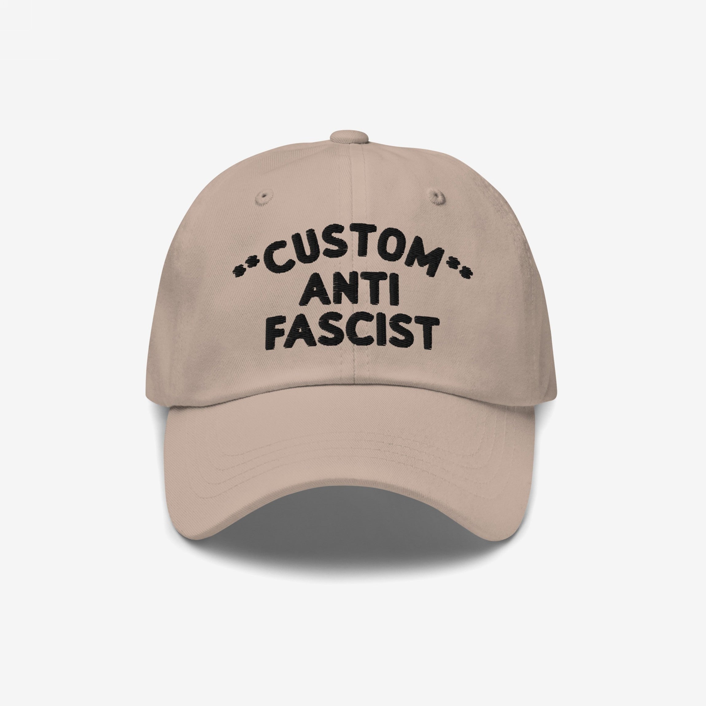 Custom Anti-Fascist Dad Hat featuring black CUSTOM ANTI FASCIST embroidery on a beige, unstructured, six-panel cap with a curved bill and adjustable strap, embodying style and anti-fascist messaging.