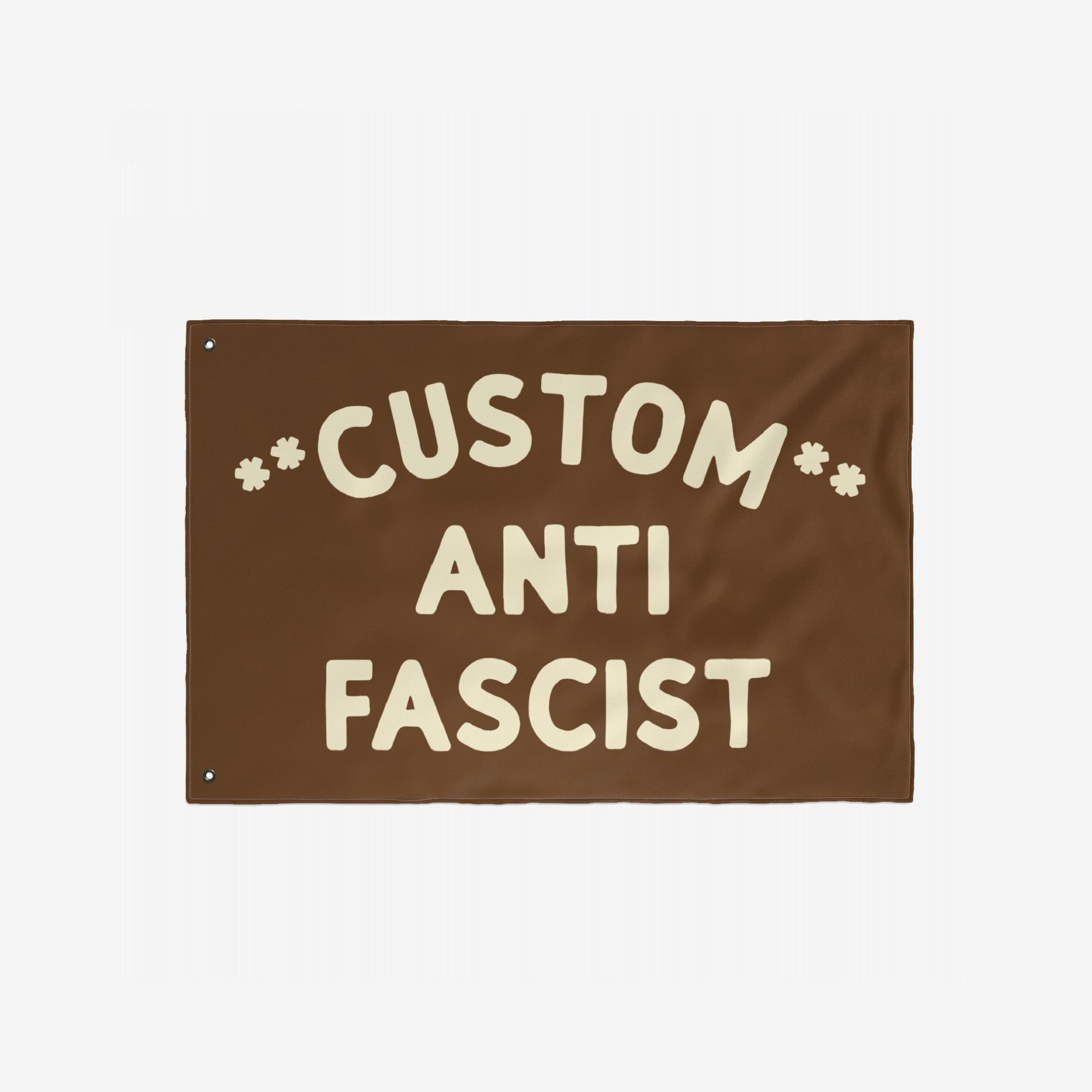Custom Anti-Fascist Flag featuring bold, cream-colored text on a durable brown banner with metal grommets, customizable to display your message, ideal for rallies or home display against fascism.
