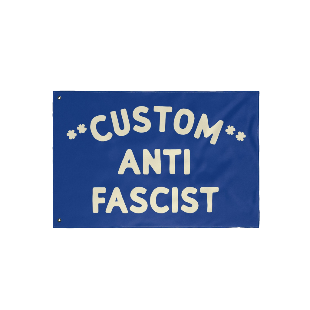 Custom Anti-Fascist Flag featuring bold off-white text on a solid blue background with grommets for hanging. Fully customizab