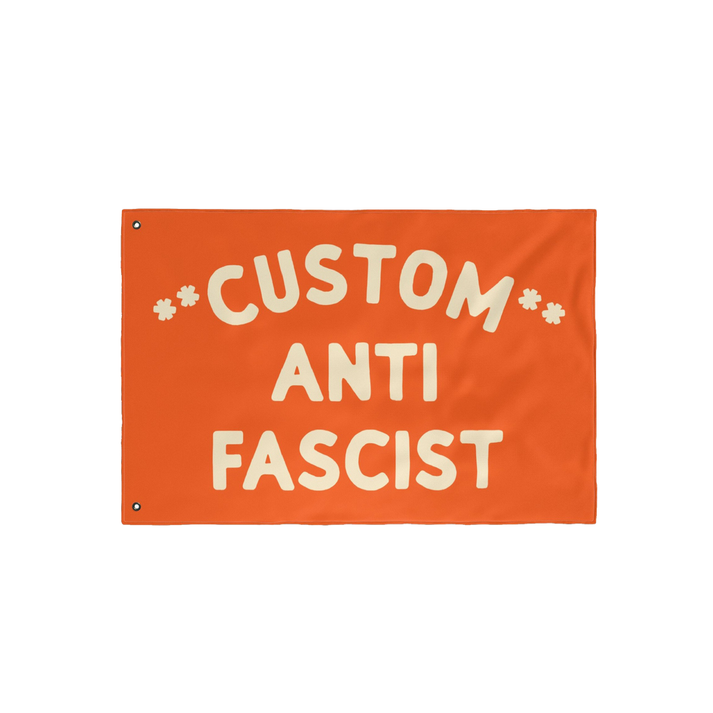 Custom Anti-Fascist Flag with bold cream letters, featuring CUSTOM ANTI FASCIST and metal grommets for hanging. Ideal for ral
