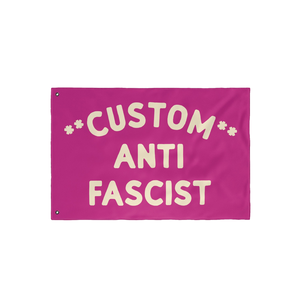 Custom Anti-Fascist Flag featuring bold cream letters on a magenta-pink background with grommets for hanging. Personalize wit