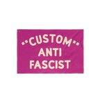Custom Anti-Fascist Flag featuring bold cream letters on a magenta-pink background with grommets for hanging. Personalize wit