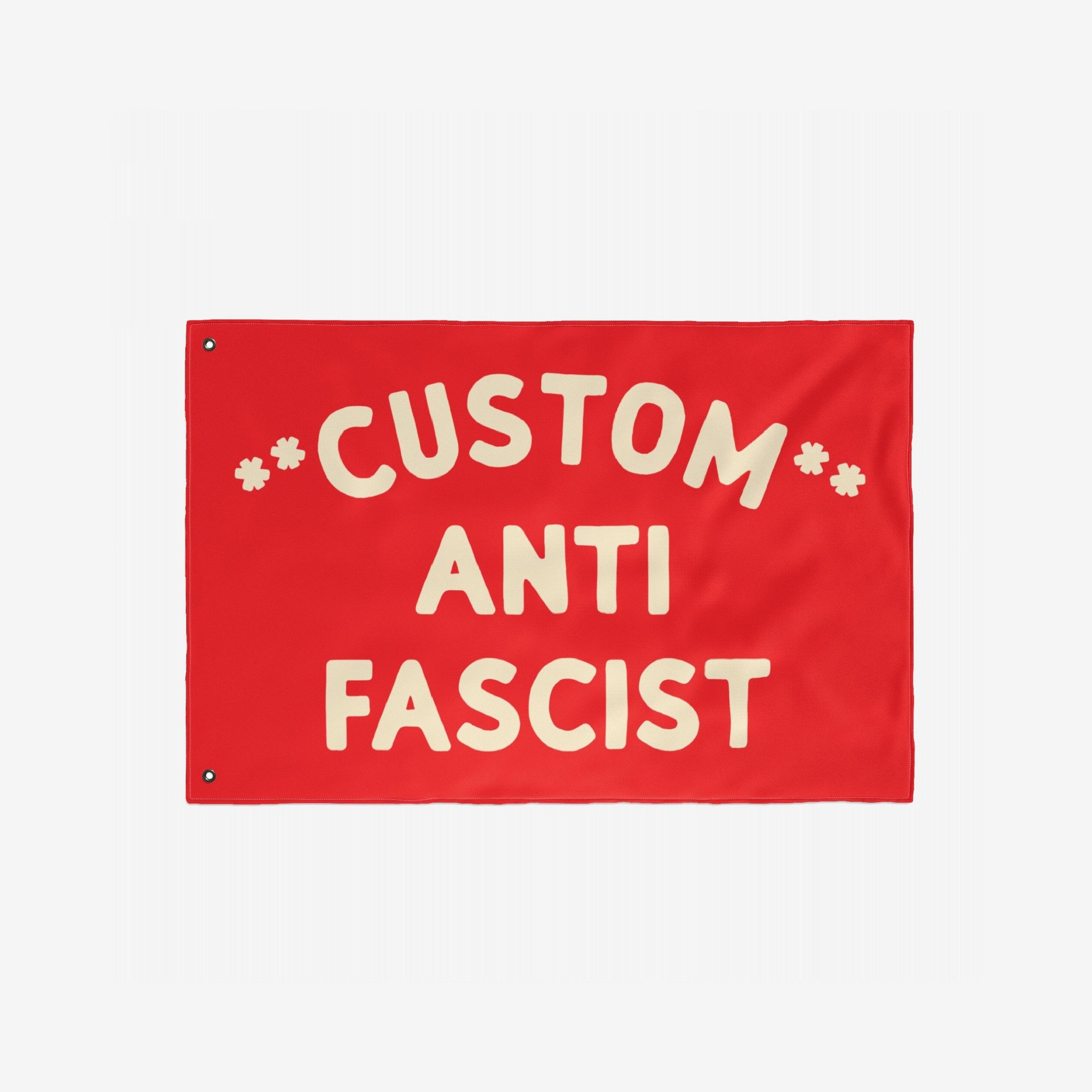Custom Anti-Fascist Flag featuring bold off-white letters on a red background, with grommets for hanging. Personalize the Custom text with your message, ideal for events or home display.