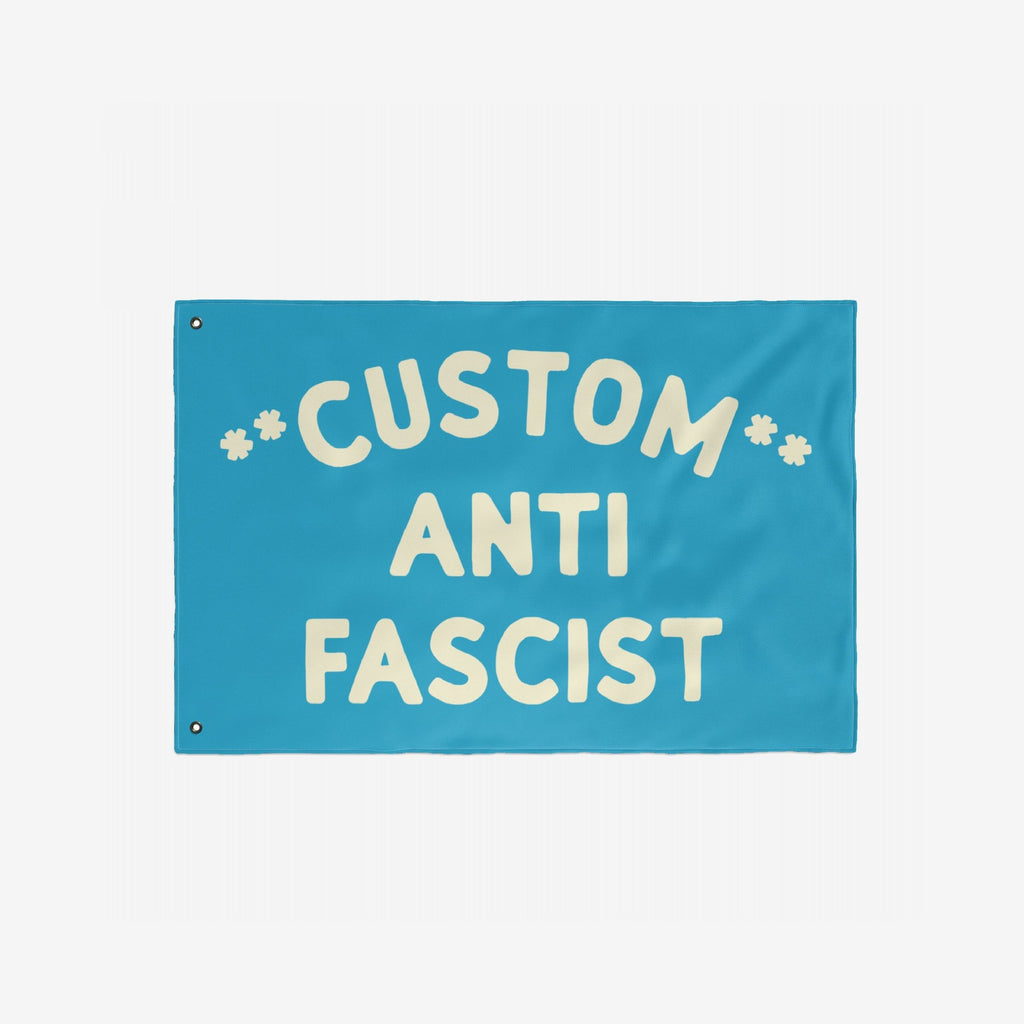 Custom Anti-Fascist Flag featuring bold, cream lettering on a bright-blue background with metal grommets for easy display, perfect for showcasing personalized messages against fascism at events or home.