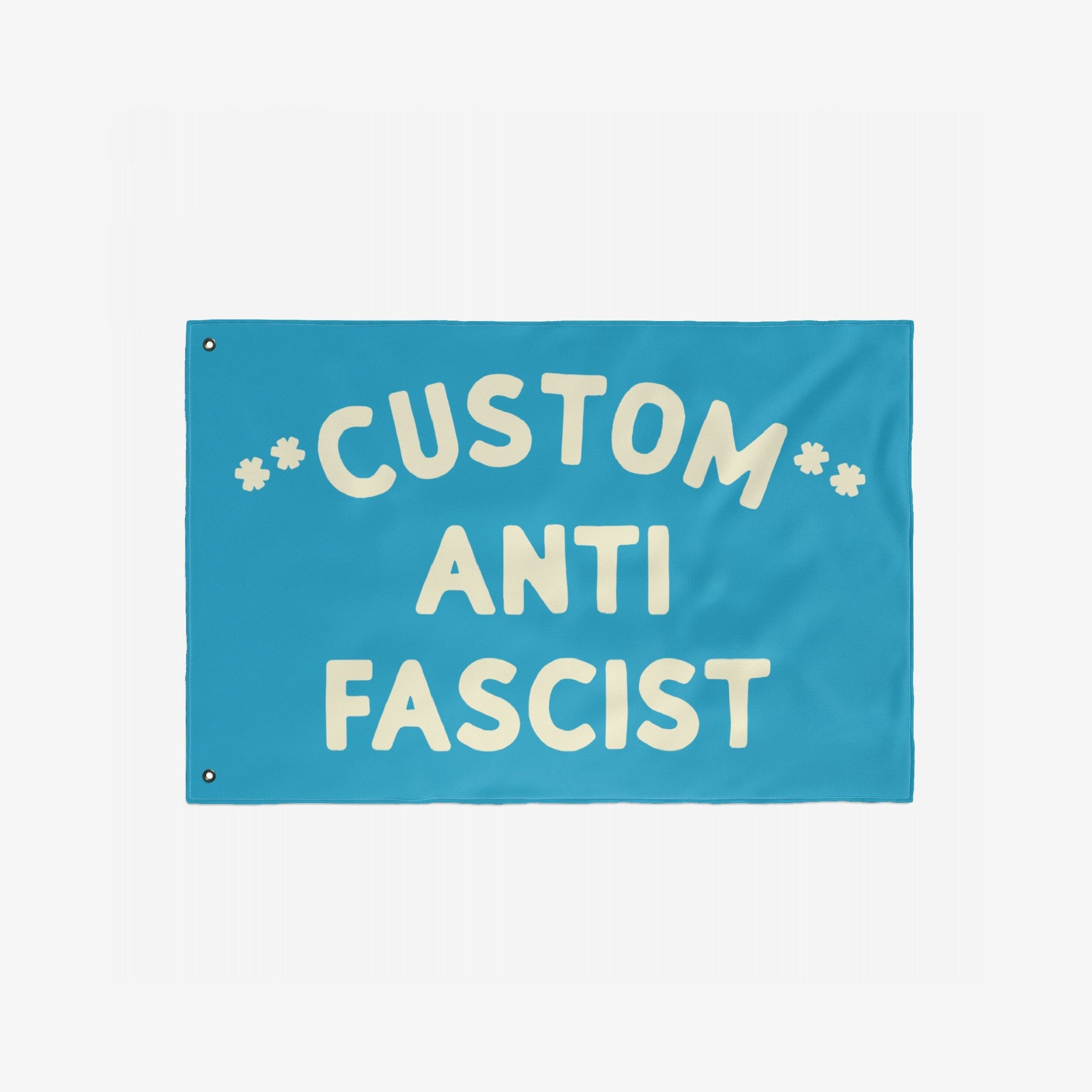 Custom Anti-Fascist Flag featuring bold, cream lettering on a bright-blue background with metal grommets for easy display, perfect for showcasing personalized messages against fascism at events or home.