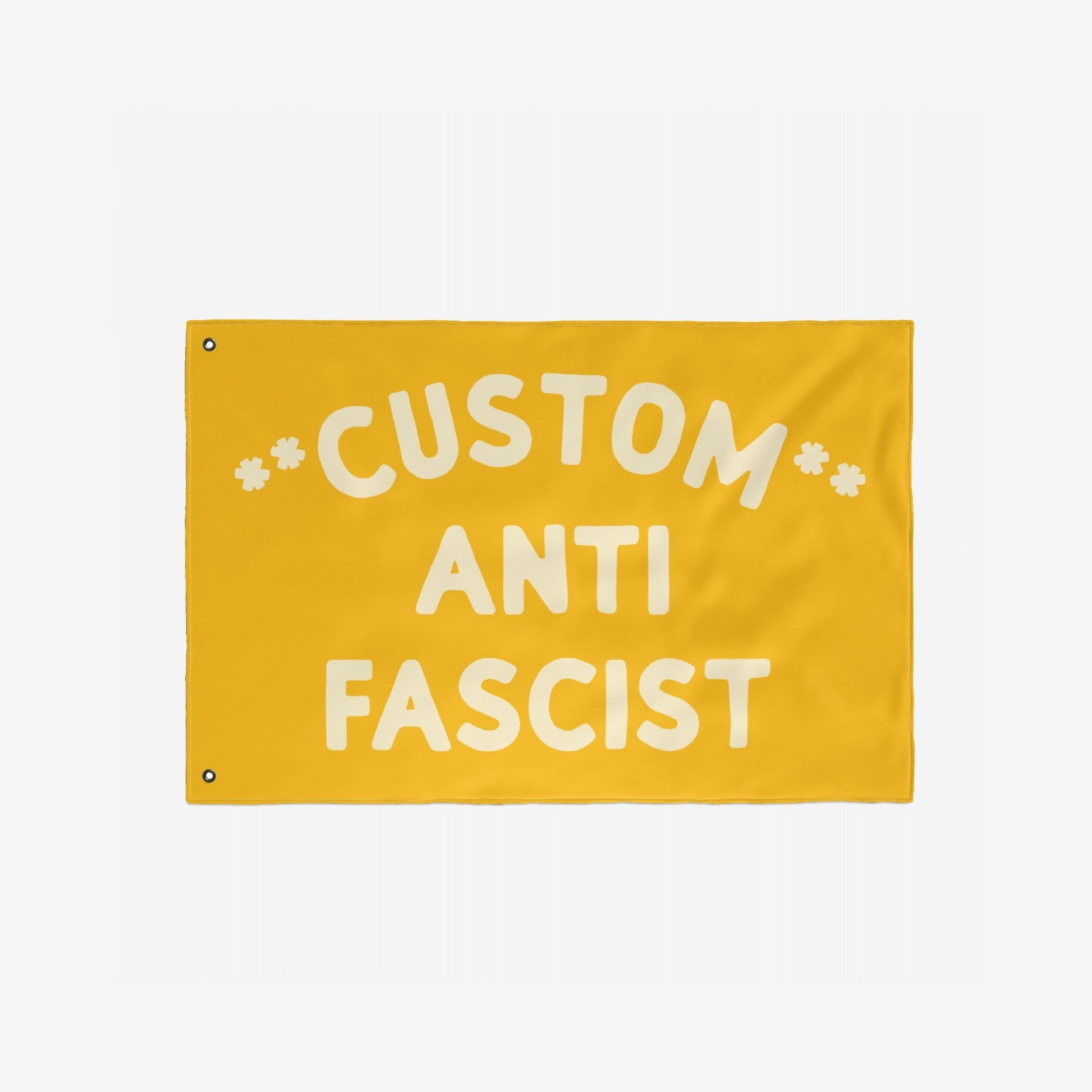 Custom Anti-Fascist Flag featuring bold off-white text on a yellow background, with two metal grommets for hanging. Ideal for promoting unity and resistance at events or home displays.