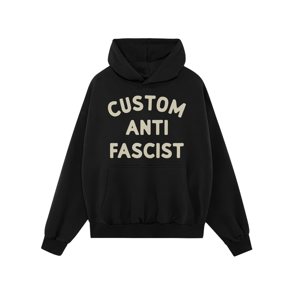 The Custom Anti-Fascist Hoodie features bold off-white text, CUSTOM ANTI FASCIST, on a black pullover with a kangaroo pocket 