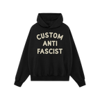 The Custom Anti-Fascist Hoodie features bold off-white text, CUSTOM ANTI FASCIST, on a black pullover with a kangaroo pocket 