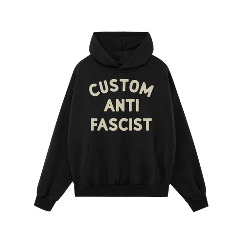 The Custom Anti-Fascist Hoodie features bold off-white text, CUSTOM ANTI FASCIST, on a black pullover with a kangaroo pocket 