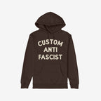 Custom Anti-Fascist Hoodie laid flat, featuring bold off-white text CUSTOM ANTI FASCIST on the chest. Includes a kangaroo pocket and drawstring hood, offering warmth and a statement against fascism.
