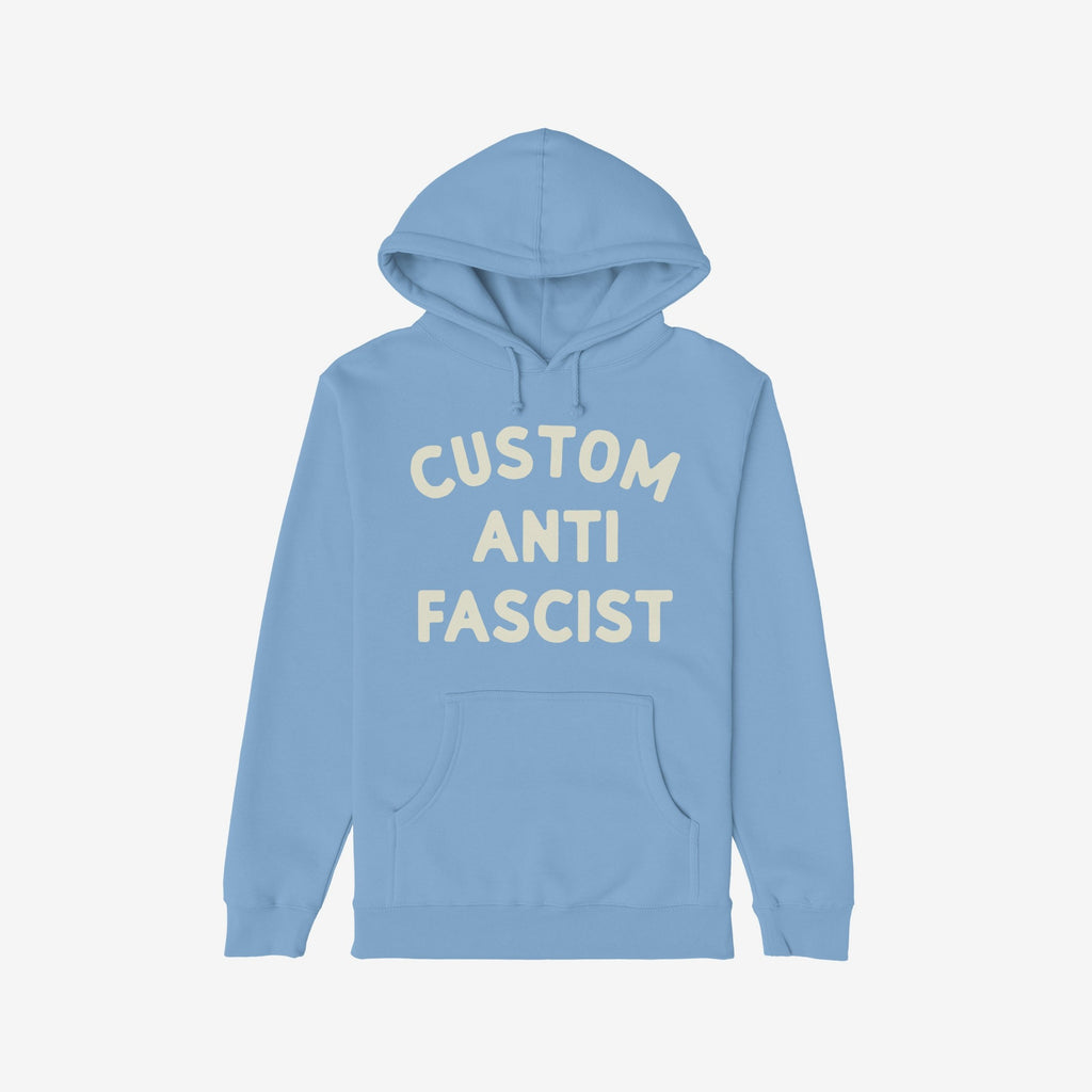Custom Anti-Fascist Hoodie featuring bold off-white block letters on the front, laid flat. Includes a kangaroo pocket and drawstrings, ideal for expressing solidarity and activism through personalized messaging.