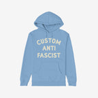 Custom Anti-Fascist Hoodie featuring bold off-white block letters on the front, laid flat. Includes a kangaroo pocket and drawstrings, ideal for expressing solidarity and activism through personalized messaging.