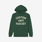 Custom Anti-Fascist Hoodie: Dark green pullover with off-white block letters spelling CUSTOM ANTI FASCIST on the chest. Features kangaroo pocket and drawstring hood. Ideal for expressing values with comfort.