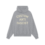 Custom Anti-Fascist Hoodie featuring bold cream text on a light-gray pullover with front kangaroo pocket, designed for person