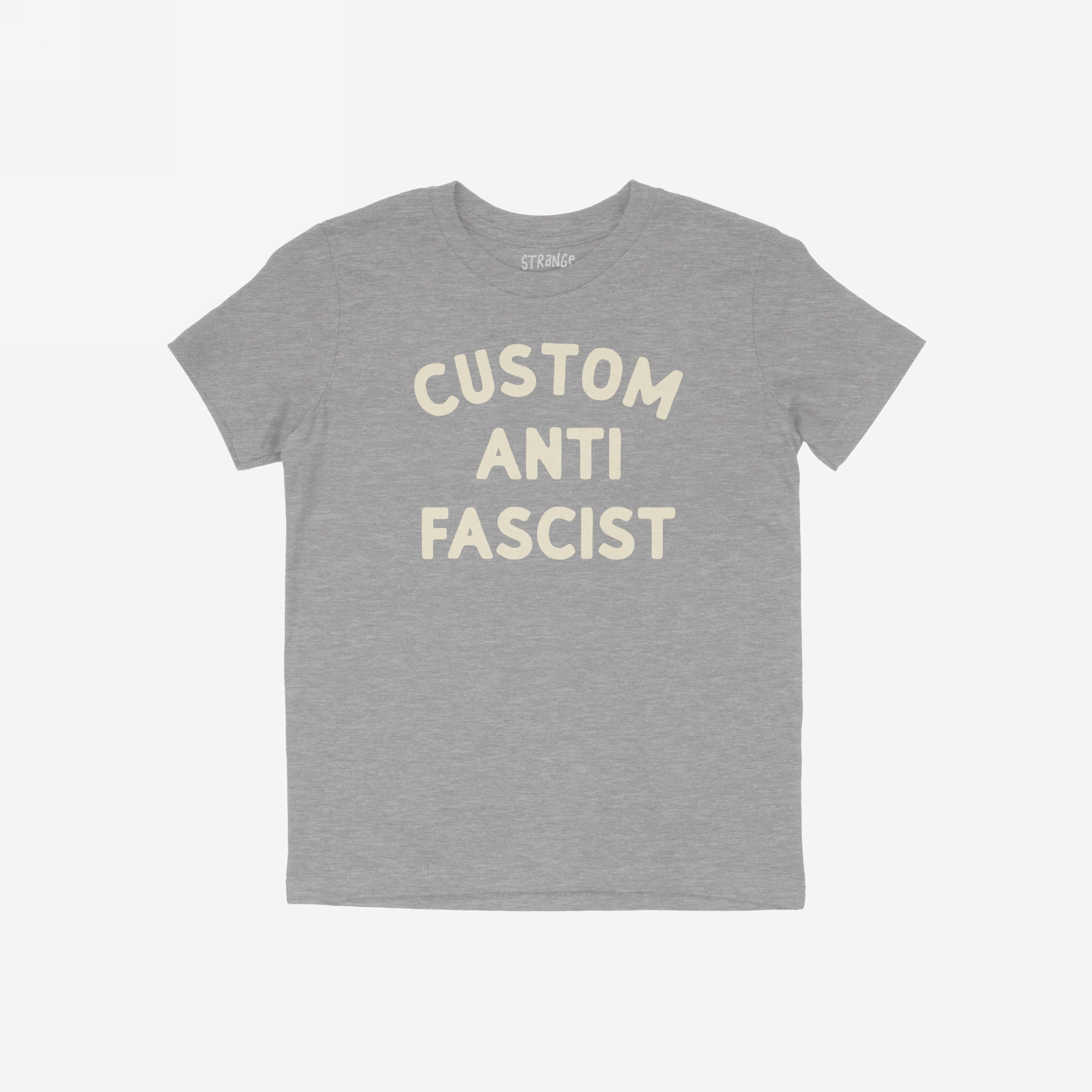 Custom Anti-Fascist Kids T-shirt featuring bold, off-white block letters on a heather-gray tee. The shirt has a crew neckline, short sleeves, and a small STRANGE. label at the collar.