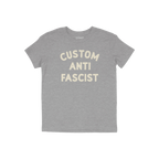 Custom Anti-Fascist Kids T-shirt featuring bold, off-white block letters on a heather-gray tee. The shirt has a crew neckline