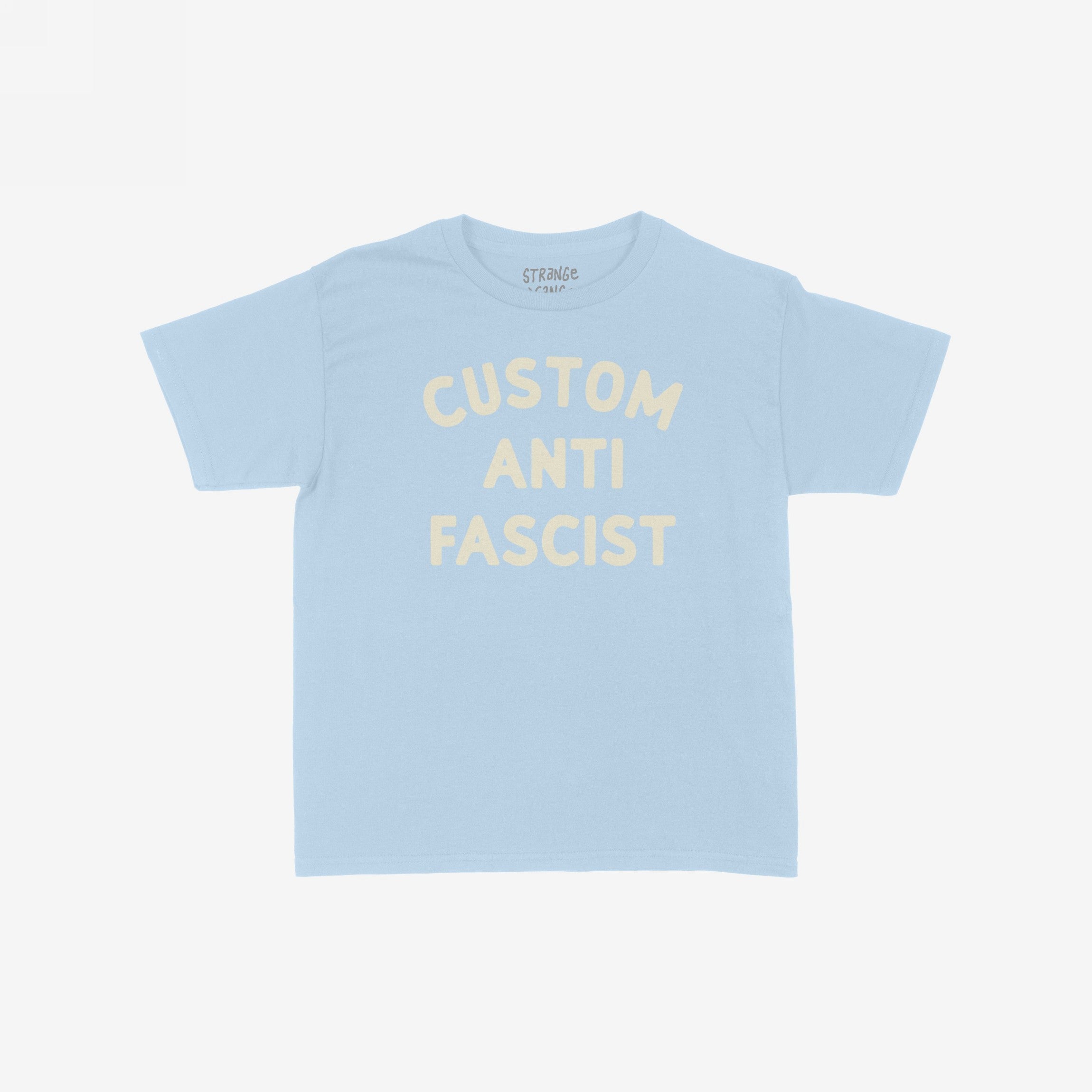Custom Anti-Fascist Kids T-shirt featuring cream block lettering CUSTOM ANTI FASCIST on a light-blue short-sleeve tee, highlighting activism and comfort. Crafted from breathable cotton, perfect for expressing youthful voices.