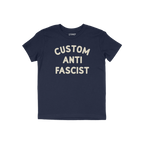 Custom Anti-Fascist Kids T-shirt featuring bold, off-white block letters reading “CUSTOM ANTI FASCIST” on the front, desi