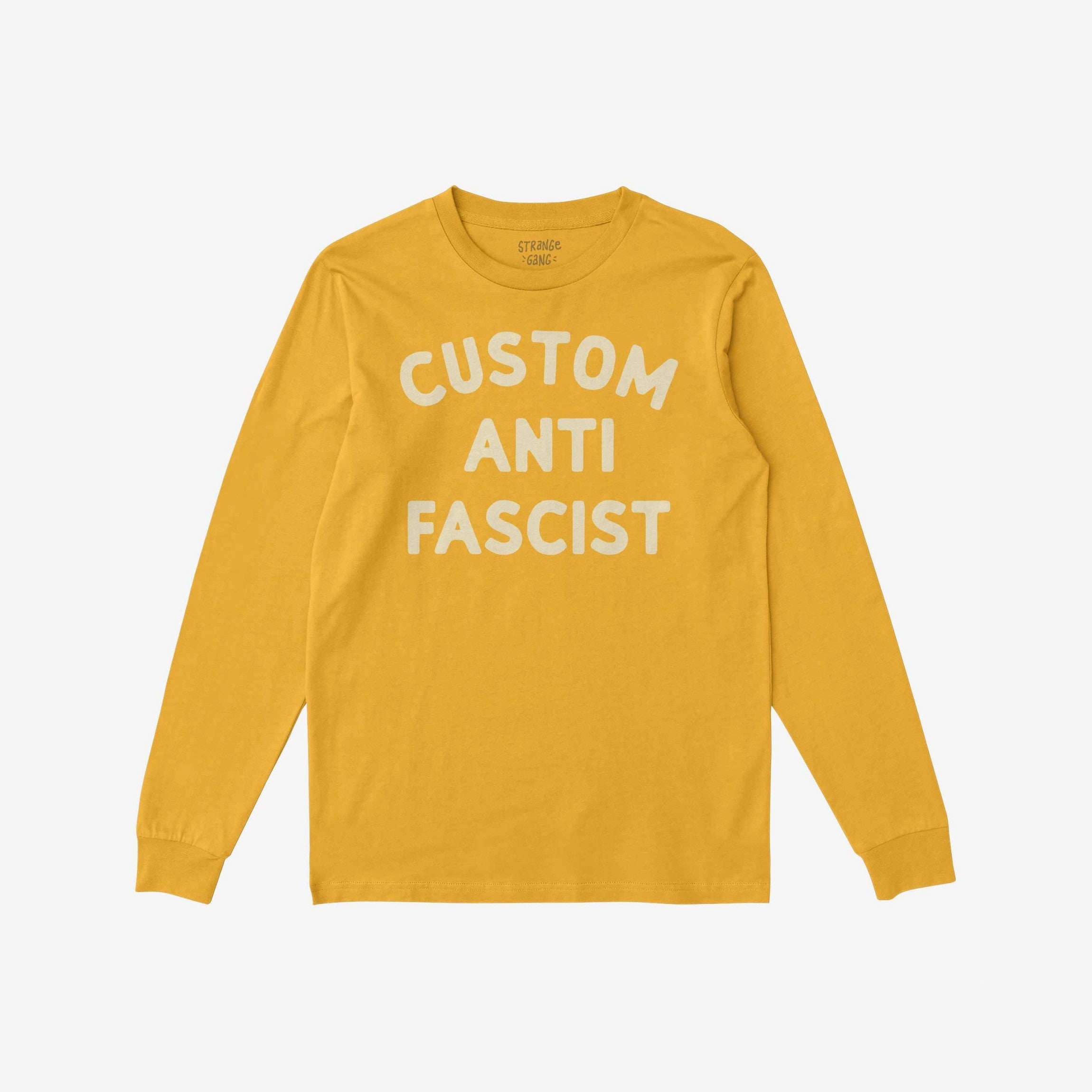 Mustard-yellow long-sleeve crewneck reading CUSTOM ANTI FASCIST in off-white. Personalize with your choice of word. Ideal for cooler days, protests, or daily activism.