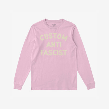 Custom Anti-Fascist Long Sleeve T-shirt with CUSTOM ANTI FASCIST in pale yellow across the chest, offering personalizable text, laid flat showcasing a comfortable, durable design for activism and cooler days.