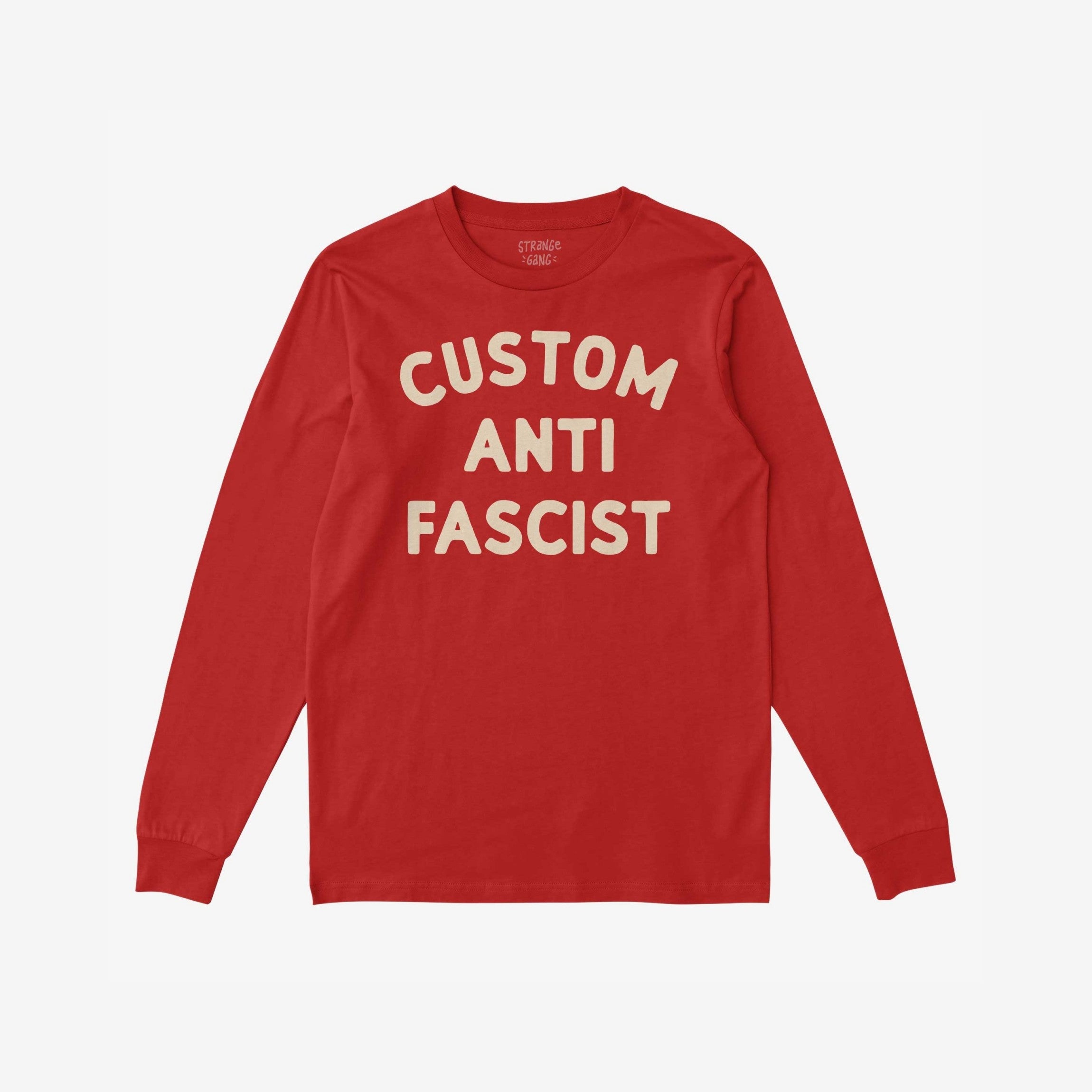 Custom Anti-Fascist Long Sleeve T-shirt laid flat, featuring bold cream text CUSTOM ANTI FASCIST on soft red fabric, inviting personalization for activism and expression.