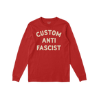 Custom Anti-Fascist Long Sleeve T-shirt laid flat, featuring bold cream text CUSTOM ANTI FASCIST on soft red fabric, inviting