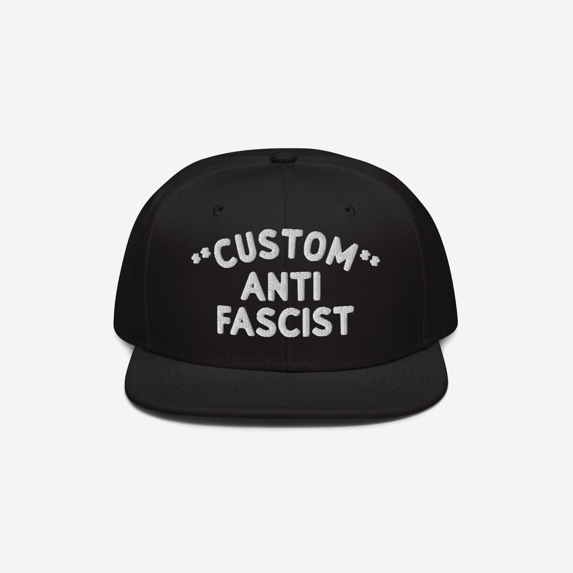 Custom Anti-Fascist Snapback Hat with bold white embroidery on a black flat-brimmed cap, featuring adjustable closure. Personalize the Custom text, showcasing your stance against fascism with style and comfort.