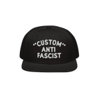 Custom Anti-Fascist Snapback Hat with bold white embroidery on a black flat-brimmed cap, featuring adjustable closure. Person