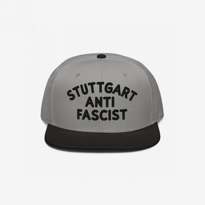 Custom Anti-Fascist Snapback Hat with STUTTGART ANTI FASCIST black embroidery on a two-tone cap, featuring a light gray crown and black brim, designed for a bold, personalized anti-fascist statement.