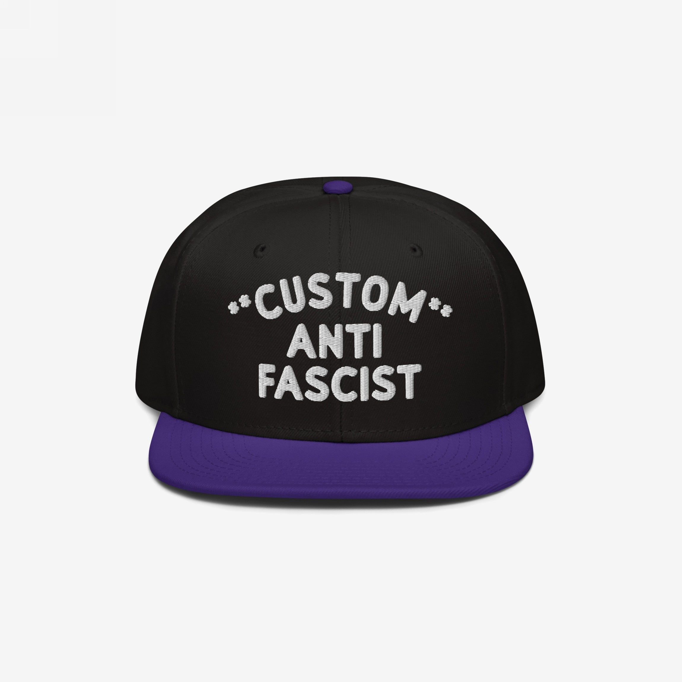 Custom Anti-Fascist Snapback Hat with a black crown and deep purple brim, featuring bold white embroidery that reads CUSTOM ANTI FASCIST on the front, adjustable for a personalized, impactful statement.