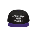 Custom Anti-Fascist Snapback Hat with a black crown and deep purple brim, featuring bold white embroidery that reads CUSTOM A