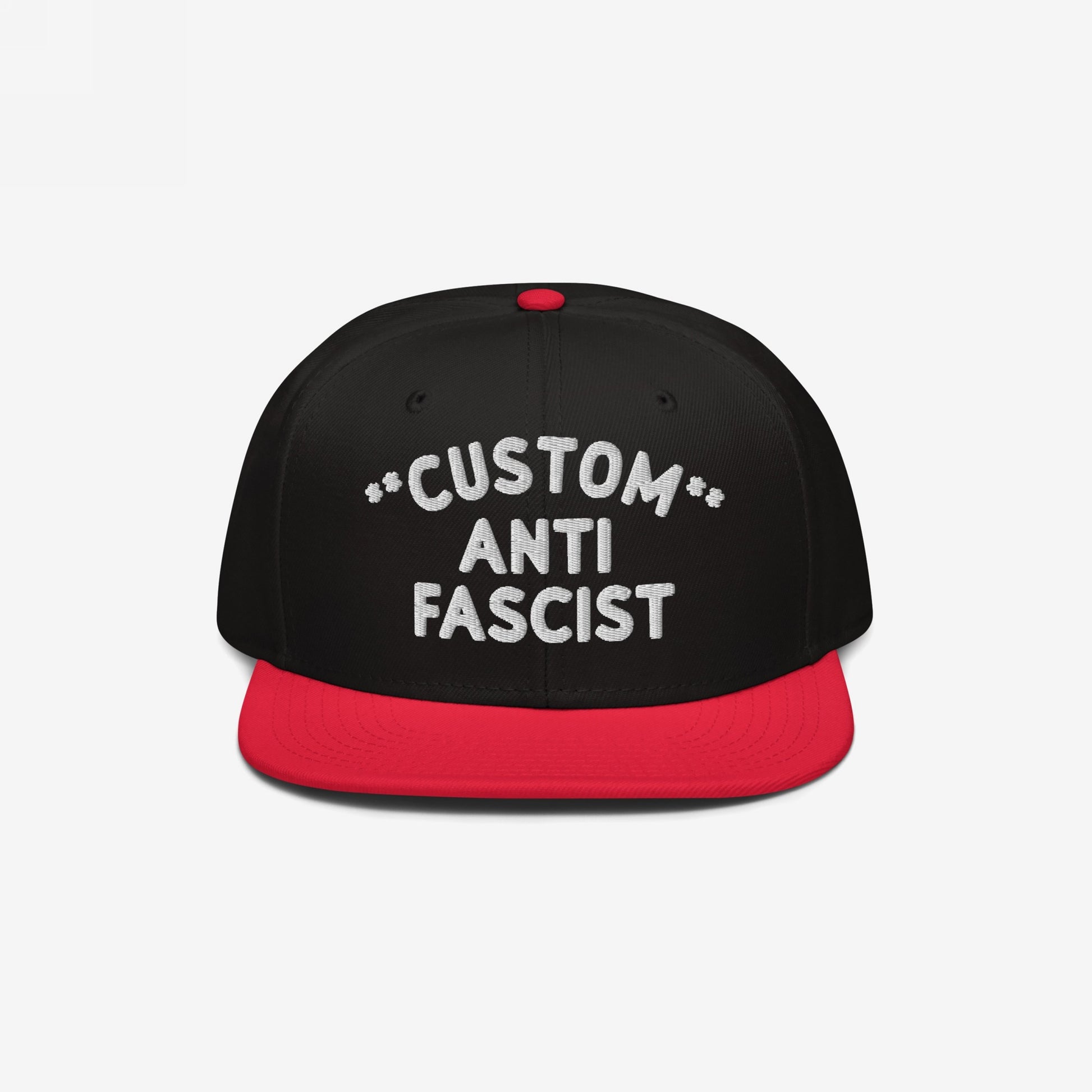 Custom Anti-Fascist Snapback Hat featuring a black crown with red bill and button, highlighted by bold white embroidered text. This adjustable cap offers a personalized anti-fascist message, combining comfort and style.